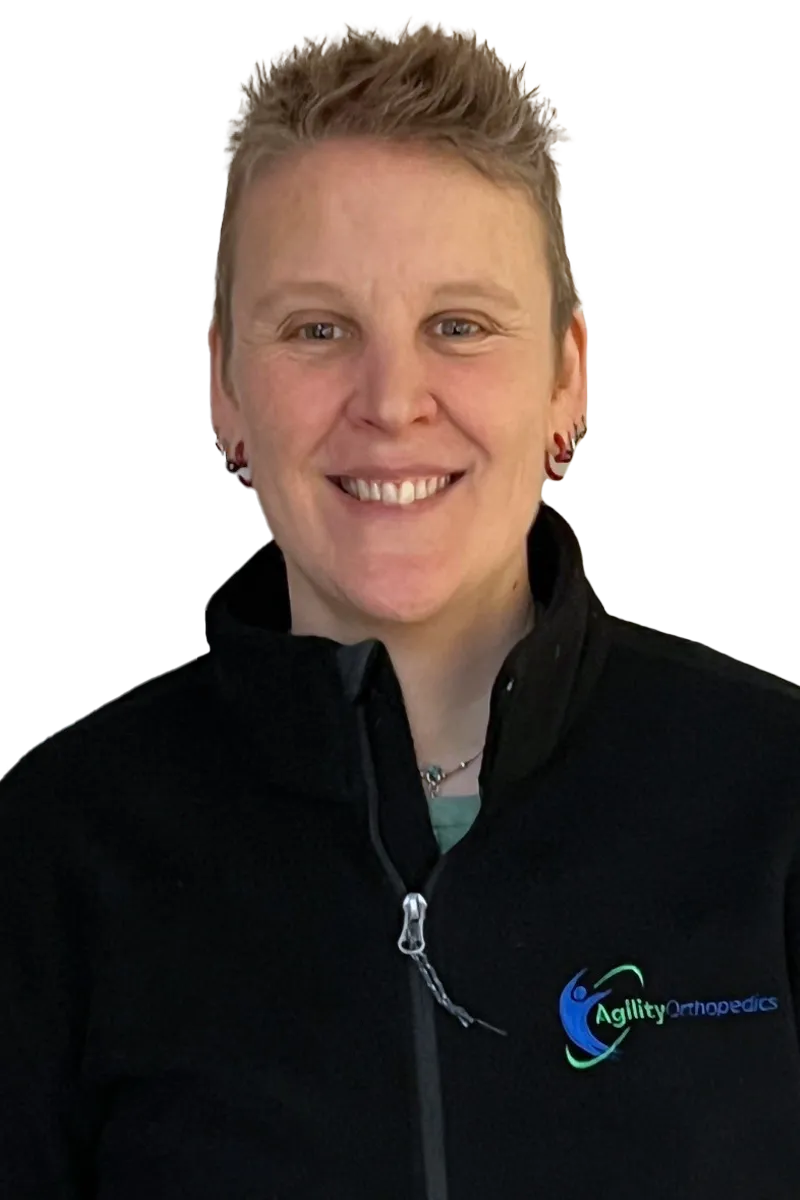 Portrait of a smiling person in an Agility Orthopedics jacket on a white background.